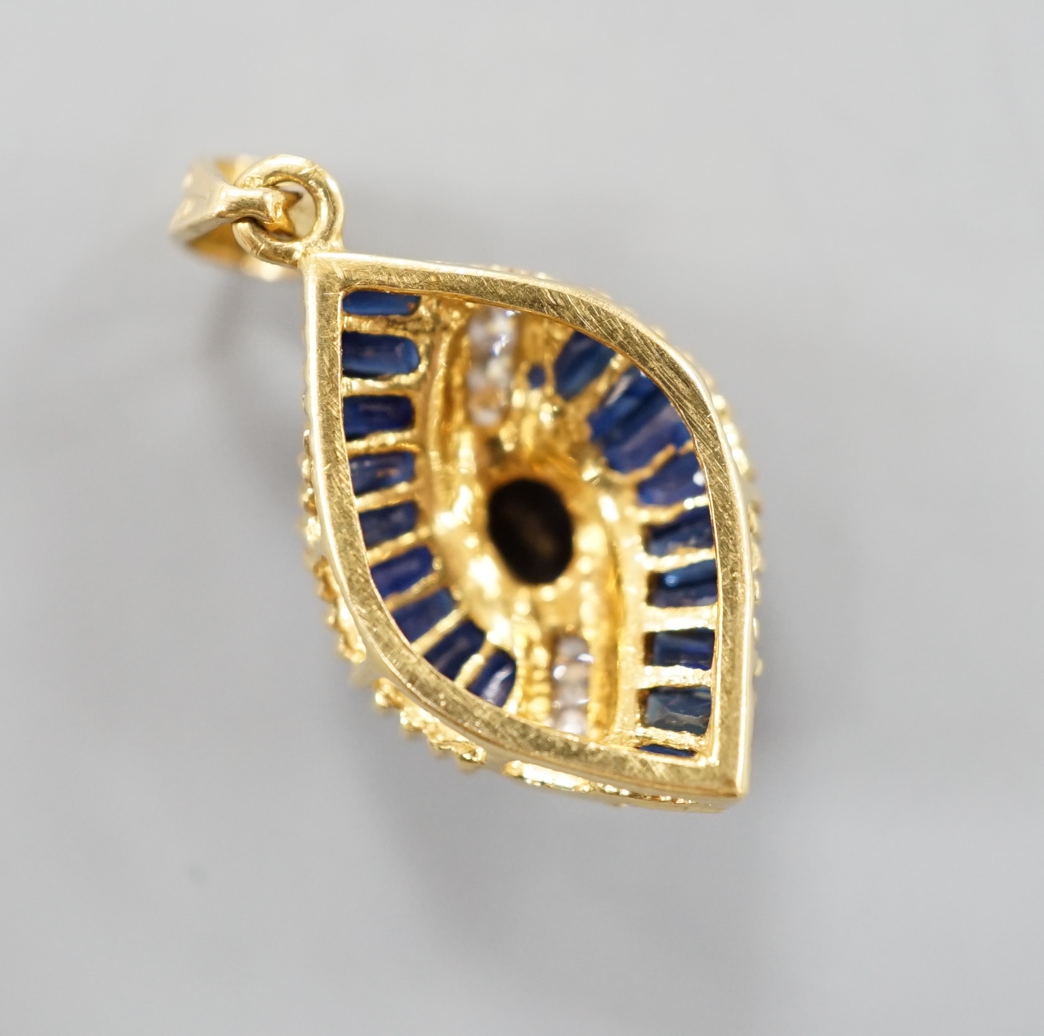 A modern gold, sapphire and diamond cluster set oval pendant, 19mm, gross 3.9 grams.